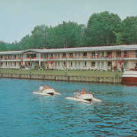          1004V Water Skeeters paddling in front of Ship and Shore Boatel; 56241-B copyright 1962, L.L. Cook Co., Milwaukee
   