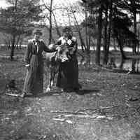          2 women and cow.jpg 6-8KB; Two women in ankle-length skirts standing with a cow by a river.
   