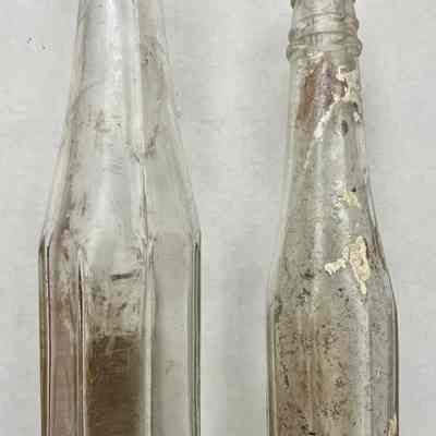 Two ketchup bottles, one with "Heinz" molded in bottom.