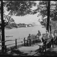          95 84 20 No. Park St. view.jpg 1.1MB; Box 31, envelope 95-84-20 
A mature man and woman, two young men and a boy sit on benches along the west bank of river, downstream from the chain ferry crossing. The Big Pavilion, Hotel Mt. Baldhead and a pair of people in a canoe are visible in the background.
   