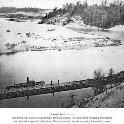 16ShriversBend.jpg 1.3MB: From Jack Sheridan's History By Camera "View from a high dune on the sough bank of the old channel. The village, ships and docks of Singapore are visible in the opper left of the photo. The tug moored at the pier is probably "Shriver Bros."