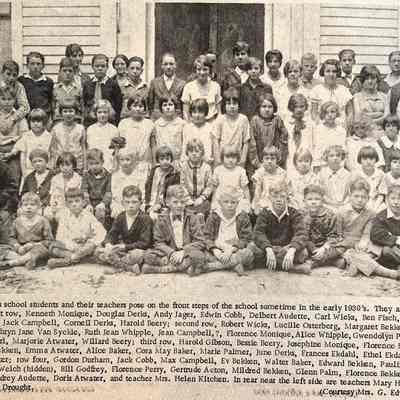 page 14 detail: Douglas school students and teachers sometime in the early 1930s - Douglas school students and their teachers pose on the front steps of the school sometime in the early 1930's. They are (left to right: First row, Kenneth Monique, Douglas Derks, Andy Jager, Edwin Cobb, Delbert Audette, Carl Wicks, Ben Fisch, Buren Osterberg, Jack Campbell, Corneil Derks, Harold Beery; second row, Robert Wicks, Lucille Osterberg, Margaret Bekken, Claude Perry, Kathryn Jane Van Syckle, Ruth Jean Whipple, Jean Campbell, ?, Florence Monique, Alice Whipple, Gwendolyn Plummer, a Godfrey girl, Marjorie Atwater, Willard Beery; third row, Harold Gibson, Bessie Beery, Josephine Monique, Florence Ekdahl, Kathryn Bekken, Emma Atwater, Alice Baker, Cora May Baker, Marie Palmer, June Derks, Frances Ekdahl, , Ethel Ekdahl, Ethel May Atvater; row four, Gordon Durham, Jack Cobb, Max Campbell, Ev Bekken, Walter Baker, Edward Bekken, Pauline Leonard, Lawrence Welch (hidden), Bill Godfrey, Florence Perry, Gertrude Acton, Mildred Bekken, Glenn Palm, Florence Bekken, Donald Acton, Audrey Audette, Doris Atwater, and teacher Mrs. Helen Kitchen. In rear near the left side are teachers Mary Hans and Mrs. Flora Drought (Photo courtesy Mrs. G. Edward Wark)