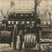 Saugatuck Fire Department men with firehose carts
