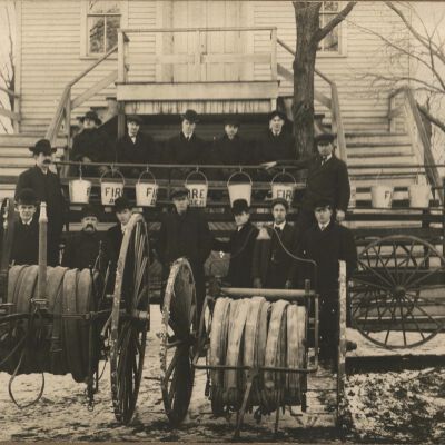 Saugatuck Fire Department men with firehose carts