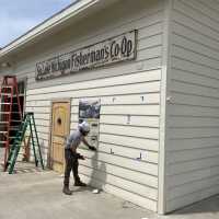          Southern Lake Michigan Fisherman's Co-op sign, signed by Dan Cook; Masonite and wood sign was treated with moisture and UV-protective clear coat before installation. Sign installed on Harrington Boathouse next door to Shanty in May 2021
   