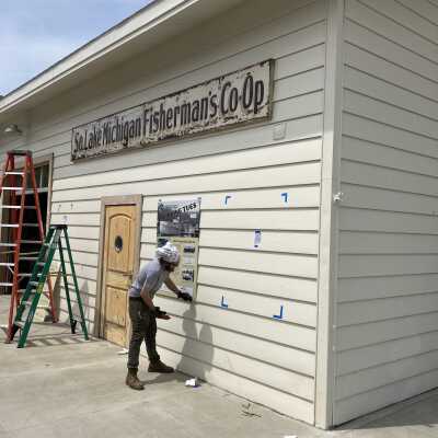Southern Lake Michigan Fisherman's Co-op sign, signed by Dan Cook: Masonite and wood sign was treated with moisture and UV-protective clear coat before installation. Sign installed on Harrington Boathouse next door to Shanty in May 2021