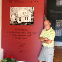          SDHC historian James Schmiechen posed by the intro panel for a 6-29-2006 newspaper story
   