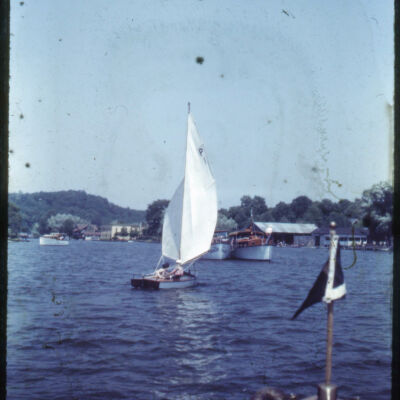 SYC006.jpg 2.9MB: According to Jack Sheridan, "this appears to be the 'Ruth' built and designed by Robert Fort. Note on the sail the designation P1. Also one of the boats in the background has large registration numerals - this dates photo 1942-45."