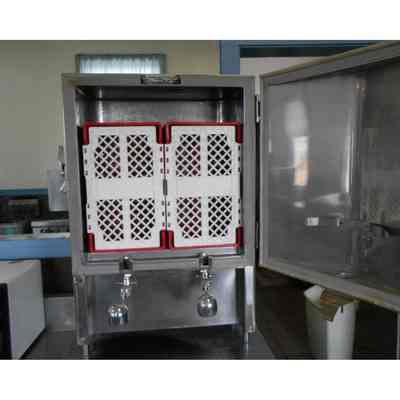 Open Norris institutional double milk dispenser with weighted valve visible at bottom.