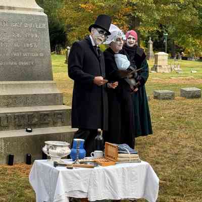 Ralph Hamilton, Julie Abel and Jacqueline Carey as William, Eliza and Emily Butler beside props assembled to evoke the Butler trading post.: Event photo by Kathy Fries-Wilson