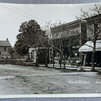          The north side of Center street between Washington and Main, probably about 1900. Stores are, from left, a barber shop, hardware and grocery.
   