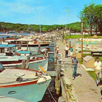 Boat.Postcard.jpg 1.5MB: Digital file on Jack Sheridan Drive 2021.72.02 pleasure boats docked at boardwalk behind the Butler. According to Jack Sheridan, this circa 1963 postcards shows dock attendant Ron Chase walking in the foreground.