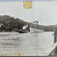 Tug towing loaded steamship