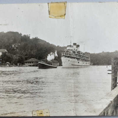 Tug towing loaded steamship