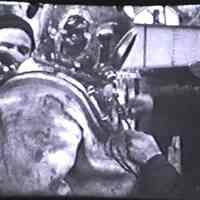          preparing deep-sea diver's helmet for inspection
   