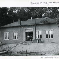          04.06.024 exterior view 1917; Proud workers pose after doubling the building size in 1910.
   