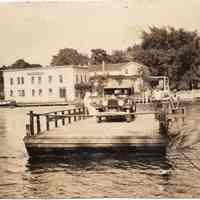          JimorGeorgeCrankingFerry.jpg; Original photo. Jim or George Sheridan cranking ferry. Note about Heath Boats down river. ca 1929 to 1935
   