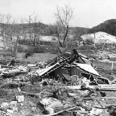 Mod3 Likely to Use - 49.jpg 1.7MB: This image was featured for History Mystery#2 with the solution: Wreckage of the 1859 lighthouse after being struck by a tornado in April 1956. The owner, Arthur Deam, can be seen picking through the debris. About five years later, the present cottage was built on the old lighthouse site (just north of Oval Beach).