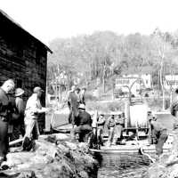          HM67LayingPipeRiver; This image was featured as History Mystery #65 with the solution: Village Public Works crew  laying new water pipe on the river bottom ca 1950.
   