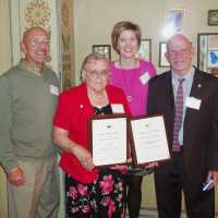          Vic Bella, unknown lady in red, Sally Winthers and Jim Schmiechen collect Michigan Historical Society award
   