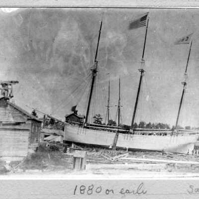 Case_3_mast_ed_schooner: "The vessel is the George M. Case. The hull was made in Allegan and floated down the river to this location near the end of Butler Street. I believe the foreground building on the left was part of Morrison's tannery business - there was a windmill on the roof used to power a hemlock bark grinder. The Saugatuck Union School house overlooking Lake and Allegan streets is in the background. The area on the river bank is between the Griffith sawmill and Butler Street."
Source: jack.sheridan@gmail.com