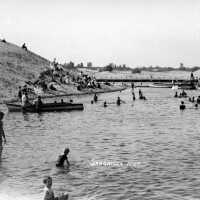          Swimming beach just inside the new piers ca 1910.; Basin beach postcard
   