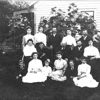 Book_2003_4.03A.jpg 676KB: Farmer Shumann and Family ca. 1900
German immigrant Andrew Schumann worked in a Saugatuck shingle mill, holding the record for cutting 46,000 shingles in one day. He later acquired a large farm with orchards and fields on top of "the hill" bordering on Grand Street in Saugatuck.The family is shown here at the farmhouse on corner of Francis and Grand Streets