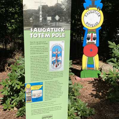 Interpretive sign added August 2020: Features photo of the pole in its original location at Lake and Blue Star Highway (Arrowhead Motel in the background), a membership decal (2017.31.10) and 1963 tourism brochure.