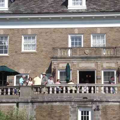 © The Holland Sentinel June 26, 2013: Graduates of St. Augustine Seminary High School and their families talk on the balcony at the Felt Mansion on Saturday, Aug. 11, in Laketown Township. The mansion was once used by the Augustinians to house and educate seminary students. Jim Hayden/Sentinel staff