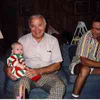          Unknown infant, mature man and John Otto, son of Tom, in striped shirt
   