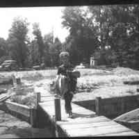          D0011.jpg 4.1MB; Boy, possibly George Worthington, in striped shirt caring gear for a boat trip
   