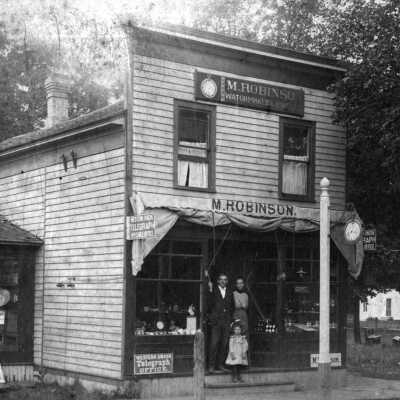 Photo caption - Robinson family, front of shop ca 1902: filename: Robinson shop Butler st ca 1890