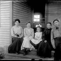          Sim Family Picture.jpg 505MB; Simonson family members sitting on the front steps of a farmhouse. Erma (Crow) Simonson, Sophia (Simonson) Roblyer, unknown girl, Marie Helen Simonson and Herman Simonson.
   