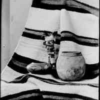          sim indian pottery mn101.jpg 480KB; Still life photo of two ceramic pots, one with southwestern Native American decorations, a Hopi katsina figure or kachina doll and a woven blanket.
   