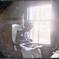          HH-MamaCuttingBeans-2.jpg 1.5MB; Seated woman with papers and bowls in her lap, head bent to her work.
   