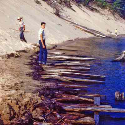 Singapore site JACK 1952.jpg 925kb: Jack Sheridan posing on Singapore dock remains exposed by 1952 low water levels