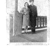          89-1-75 Edgecomb.jpg 604MN; L to R M Edgecomb [Edgcomb] Bill  - WWII era clothing, standing on bridge
   