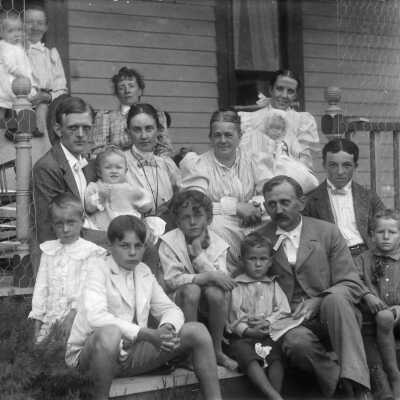 Johnson - Benson families ca 1900: The Benson and Johnson families on the front steps ca 1899.  James Johnson is the man in the front row.  His wife, Phoebe Johnson is sitting just behind him.