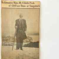          —Photo by L. C. Robinson.
EBER SNOW AT TOP OF OLD BALDHEAD
Eber Snow Scale Famous Old Baldhead, Feat Many Young People Refuse to Try; Enjoys Rare Views.
Shaking his cane at Father Time, Eber Snow, 80, a few weeks ago climbed the sandy summit of Old Baldhead, 450 feet high, 
The climb is a severe and trying one for youngsters. But the Kalamazoo octogenarian scaled the heights with apparent ease.
Mr. Snow resides with his daughter, Mrs. James Myers of Lincoln Avenue. For a long time the Kalamazoo man had a desire to mount to the peak of Saugatuck's famous sand dune. People who have performed the feat relate in glowing terms the splendid panorama which presents itself to view once the top is reached.
NO EASY PATHS
But the way to the top of the dune is an arduous one. There is no easy path. Tracks at a steep elevation lead through the rolling and shifting sands. Young people who have climbed Old Baldhead are inclined to brag about it. They would scoff at the thought of an 80-year-old man attempting to climb its rugged sides.
However, Mr. Snow, when on a family party at Saugatuck last month decided that he would attempt the climb. On a bright Sunday morning he started out. In less than three quarters of an hour he was at the top.
