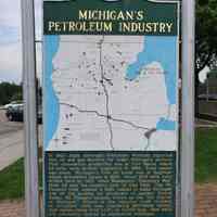          Michigan's Petroleum Industry Historical Marker near Clare, Michigan; In 1860 State Geologist Alexander Winchell reported that oil and gas deposits lay under Michigan's surface. First commercial production was at Port Huron where 22 wells were drilled, beginning in 1886. Total output was small. Michigan's first oil boom was at Saginaw, where production began in 1925. About 300 wells were drilled here by 1927, when Muskegon's 