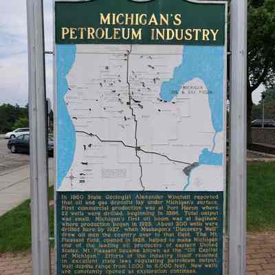 Michigan's Petroleum Industry Historical Marker near Clare, Michigan: In 1860 State Geologist Alexander Winchell reported that oil and gas deposits lay under Michigan's surface. First commercial production was at Port Huron where 22 wells were drilled, beginning in 1886. Total output was small. Michigan's first oil boom was at Saginaw, where production began in 1925. About 300 wells were drilled here by 1927, when Muskegon's "Discovery Well" drew oil men the country over to that field. The Mt. Pleasant field, opened in 1928, helped to make Michigan one of the leading oil producers of eastern United States. Mt. Pleasant became known as the "Oil Capital of Michigan." Efforts of the industry itself resulted in excellent state laws regulating petroleum output. Well depths range from 1,000 to 6,000 feet. New wells are constantly opened as exploration continues.