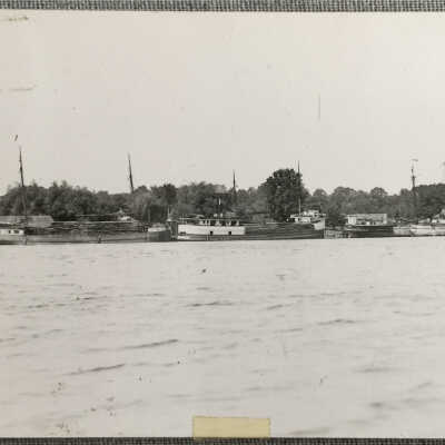 Masted cargo ships loaded with wood