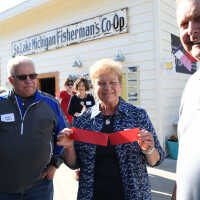          Jeffery Peel, Marilyn Hebert (with ribbon) and spouse Lou Hebert
   