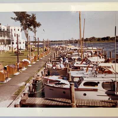 excellent color photo of boardwalk and docks behind Butler Hotel