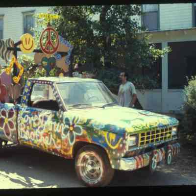 TruckPaintjob.jpg 412KB: decorated pickup truck with peace symbols, flowers and smiley faces