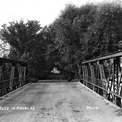 BridgeNorthEnd1913.jpg 1.1MB: Road to Douglas, circa 1920 - Douglas viewed from near the end of the steel truss portion. In the early 1900s the first wooden plank bridge was rebuilt utilizing used steel bridge parts brought from New York state.