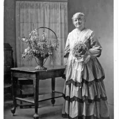 MayCentennialGown.jpg 699KB: May at the 1930 Centennial Ball

Local residents of mature years may remember the Saugatuck "centennial" of 1968 and the Douglas "centennial" of 1970, which commemorated the formal incorporation of each city. Posters from these events can still be found at the Douglas antique mall.

Forty years earlier, on July 14-15-16, 1930, there was a first centennial. This one celebrated the settlement of the community by William Butler, who arrived here in the fall of 1829. May Heath was General Chairman of the 1930 centennial committee. She instigated the celebration, orchestrated the many events, and even wrote a 228 page local history which was published in time for the celebrations.

In November 1929, May had attended the Van Buren County Centennial in Paw Paw, MI to get ideas for a Saugatuck celebration. On Feb 14, 1930, the Commercial Record reported on a public meeting in the village hall, during which May Heath "was chosen chairman of the meeting and also chairman of the Centennial organization, a wise choice, since she will inspire the whole corps of assistants by her own enthusiasm. She was also given power to appoint all the committees and the several committee chairmen will form an executive committee to formulate and promote a working plan." The July dates were selected to align with the annual Jackson Park (Chicago) Yacht Club regatta on 15 July.

The next month, the paper announced Mrs. Heath was writing "a history of the early days of Saugatuck" and she solicited input from readers. In April, the name became "Saugatuck Centennial and Homecoming" as an emphasis was being given to the return of former residents to the festivities. Chairs were appointed for the following committees: Publicity; Program-Speakers; Program-Music; Band Music; Exhibits; Evening Water Carnival-Boat Races-Venetian Night Parade; Indian Relics; Parade Arrangements; Marking Landmarks; Flower Exhibit; Posters; Float Suggestions; Old Time Pictures; Art Exhibit.

A "Centennial Open Forum" began appearing in the Commercial Record in early April in which Mrs. Heath shared plans, letters from former residents, poems and other items of interest each week leading up to the celebrations. Over 2000 pamphlets were distributed in Chicago at the Motor Boat Show, post cards were available from the Commercial Record office to send announcements to friends and family, and local students competed to produce posters advertizing the pending events. The program announced was:

MONDAY, July 14, Morning: Reception and registration, pioneer exhibits and antiques each day at the Village Hall, art exhibit. Afternoon: Columbine Garden Club flower show, ball game between local team and Riordan Drugs. Evening: Old-time costume ball at Big Pavilion. At the old fashion ball, Mrs. Heath was presented with a corsage by Saugatuck mayor Dr. H. Kreager.

TUESDAY, July 15, 10 a.m.: Big Parade of progress; 2 p.m.: Water Carnival, yacht and other races; 7:30 p.m.: Venetian Night parade; 9 p.m.: Fireworks. Fifty-seven floats were registered in the parade.

WEDNESDAY, July 16, Morning: Motor trips; dedication of Jay D. Myers memorial and memorial to old Indian burying ground; 1:30 p.m.: Speaking by prominent statesmen and a musical program at Big Pavilion; 3:00 p.m.: Baseball between the local and House of David teams.

Florence Brittain, granddaughter of Jay D. Myers (for 21 years the captain of the chain ferry), unveiled his memorial bench, and twelve-year-old Johnson Fox, a member of the Pokagon Band of the Potawatomi Indians, unveiled the memorial boulder. After college, Florence moved away, married, and died in Florida in 1992. Johnson Fox, after college and military service, lived out his life in Saugatuck and died here in 2009 at the age of 90.

Dr. Frank W. Greiner, who came from Seattle, WA to attend the centennial, wrote: "There are many people who aspire to public leadership with the thought of either honor, profit or position; but of self aggrandizement in some form, Mrs. Heath works with no such thoughts; with her it is simply to bring about the object sought, the good and pleasure of all. To the people of Saugatuck I want to say you are peculiarly fortunate to have her as a citizen. Boost her as she boosted this centennial. She deserves a big place in your hearts."

Mark your calendar now. Honor her, and what she did for the village she loved, by attending the Memorial Dedication Ceremony on August 14, 2010, 1pm, in the Saugatuck Public Square.