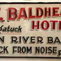         Mt. Baldhead Hotel sign hanging in the History Center's main-floor west gallery in 2026.
   