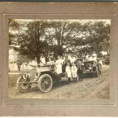 Cars with costumed people, c1910