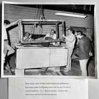          River Queen publicity photo; RIVER QUEEN BOAT WORKS STARTS FIBERGLASS OPERATION
River Queen makes first fiberglass shower-stall for use in its line of
cruising houseboats. R. J. Peterson-president, 2nd from right, helps remove mold from the first unit produced.
   